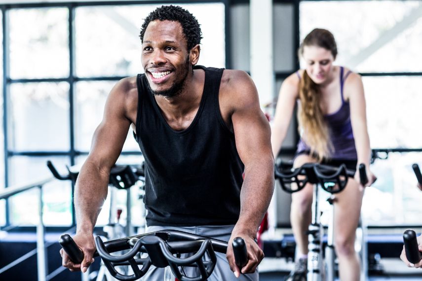 Working out at spinning class in gym